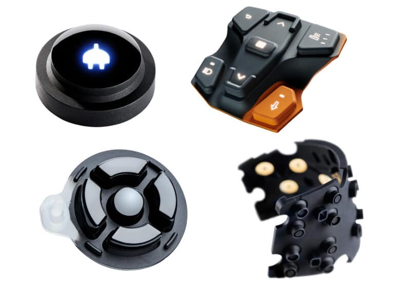 Verschiedene schwarze Tasten- und Controllerteile auf weißem Hintergrund.